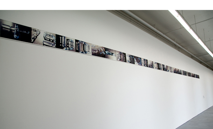 line of photographs on a wall